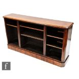 A Victorian rosewood veneered open fronted bookcase, with a bevel edged top above a plinth base,