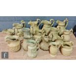 A collection of assorted 19th Century beige stoneware moulded jugs of varying form with hunting