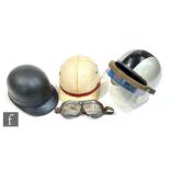 Three 1950s motorcycle helmets by Everoak, one with a visor, together with a pair of goggles. (5)