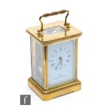 A 20th Century French brass carriage clock by Matthew Norman, white dial on bracket plinth, height