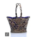 A small Dutch silver swing basket with pierced and embossed foliate and ram's head decoration