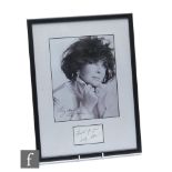 A signed black and white photograph of Elizabeth Taylor, labelled on reverse with provenance to