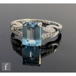 An 18ct white gold aquamarine ring, emerald cut stone to diamond set split shoulders, weight 3.4g,