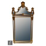 A 20th Century Chippendale style gilt wall mirror, the shaped glass panel over a square plate