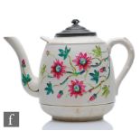 A large late 19th Century oversize novelty teapot decorated in relief with hand coloured flowers and