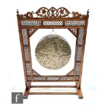 A 20th Century fret carved and panelled gong and stand with two beaters, width 74cm.