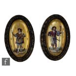 A pair of French framed oval chargers each decorated with a transfer printed and hand painted