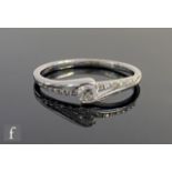 A 9ct hallmarked white gold diamond ring, central collar set stone to diamond set shoulders,