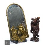 A 20th Century brass arch shaped wall mirror mounted with two classical figures near a brazier, 51cm