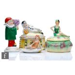 Four 1930s Art Deco trinkets comprising a bathing belle powder bowl and cover, a pin dish with a