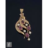 A 9ct almandine garnet and cultured pearl pendant set with four garnets and six pearls, weight 5.5g,