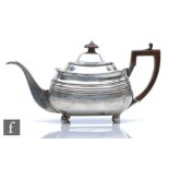 A George III hallmarked silver boat shaped tea pot with part bright cut shell decoration, weight
