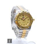 A bi-coloured lady's quartz Tag Heuer Professional wrist watch, batons and date facility to a