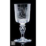 A Whitefriars clear crystal glass goblet, the cylindrical bowl hand engraved with A&M monogram and a