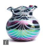 A contemporary studio glass vase of compressed ovoid form with wavy rim, decorated with white