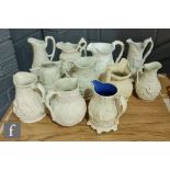 A collection of assorted 19th Century white salt glazed stoneware, bisque and parian jugs of varying