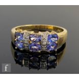 A 9ct hallmarked tanzanite and diamond ring three pairs of tanzanite spaced by diamonds, weight 2.