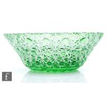 A large green cased crystal glass bowl by Michael Andrews, the flared circular form flash cut to the