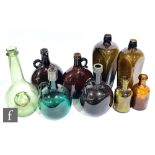 Two cased gin bottles, a pale green sealed wine bottle, four coloured decanters and two brown