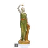 A Royal Worcester figure depicting Liberty, model 116, she stood holding aloft a dove, the whole