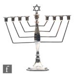 A hallmarked silver menorah, canted square base rising to angular arms supporting plain sconce,