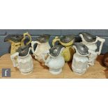 A collection of 19th Century white salt glazed stone ware pewter lidded water jugs of varying form