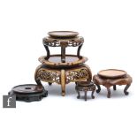 Five assorted early to mid 20th Century carved hardwood stands of varying form and size. (5)