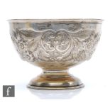 A hallmarked silver pedestal bowl with part embossed foliate decoration, weight 15oz, diameter 20cm,