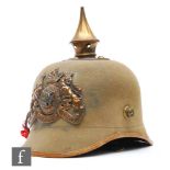 A World War One German Bavarian officer's pickelhaube in khaki with leather chin strap, helmet plate