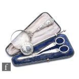 A collection of silver items to include a pair of cased grape scissors, Sheffield 1902, Atkin