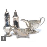 Two hallmarked silver sugar castors with two hallmarked silver sauce boats, total weight 18.5oz,