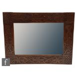 A Celtic style wall mirror of rectangular form, with carved woven knot detail to the frame, 78cm x