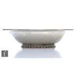 A hallmarked silver circular bowl of plain form, weight 16.5oz, diameter 23.5cm, all raised to a