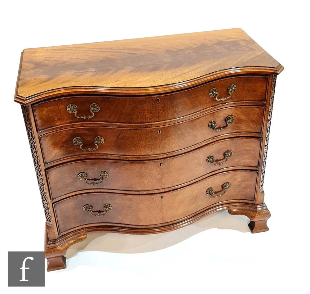 An early 20th Century mahogany serpentine fronted chest of four graduated cock-beaded drawers in the