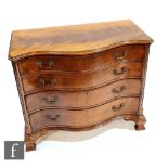 An early 20th Century mahogany serpentine fronted chest of four graduated cock-beaded drawers in the