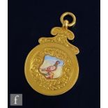 A 9ct hallmarked racing pigeon fob with central enamelled study of a pigeon, engraved to reverse '