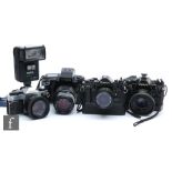 A collection of Canon cameras, to include a Canon EOS 5 fitted with Sigma zoom 135mm f.3-5/4.5,