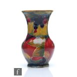William Moorcroft - A small vase of globe and flared shaft form decorated in the Pomegranate pattern