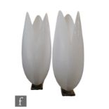 Maison Rougier - A pair of tulip form floor lamps, with white acrylic shades above stepped square