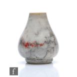 Ruskin Pottery - A miniature high fired vase of footed baluster form decorated in a mottled grey