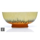 Ruskin Pottery - A large footed bowl decorated to the interior with a yellow to orange with a band
