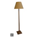 Unknown - A light oak square section standard lamp, raised from a raised square plinth base to a