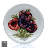 William Moorcroft - A shallow plate with a flared rim decorated in the Big Poppy (or Anemone) with