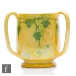 Ruskin Pottery - A small yellow lustre tyg decorated with hand painted garland, painted scissor mark
