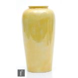 Ruskin Pottery - A vase of tapering barrel form decorated in a yellow lustre, impressed mark and