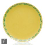 Ruskin Pottery - A large yellow lustre plate decorated with a hand painted garland to the rim