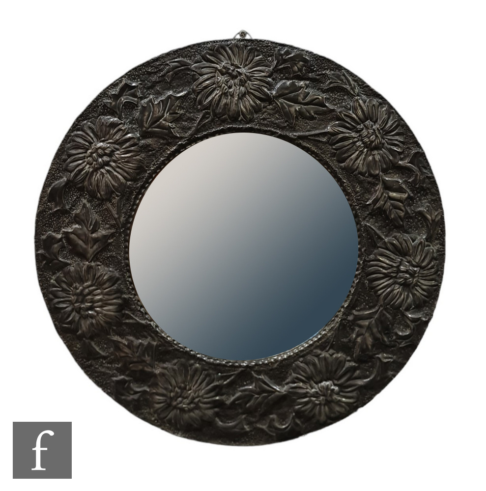 Unknown - An Arts & Crafts pewter convex wall mirror, the central domed mirror plate encircled