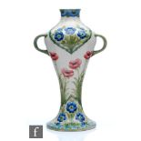 William Moorcroft - An early 20th Century twin handled vase decorated in the Poppies and Forget-me-