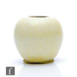 Ruskin Pottery - A miniature vase of globular form decorated in a pale yellow with pale