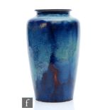 Ruskin Pottery - A high fired vase of shouldered form decorated with a sweeping lavender and ice